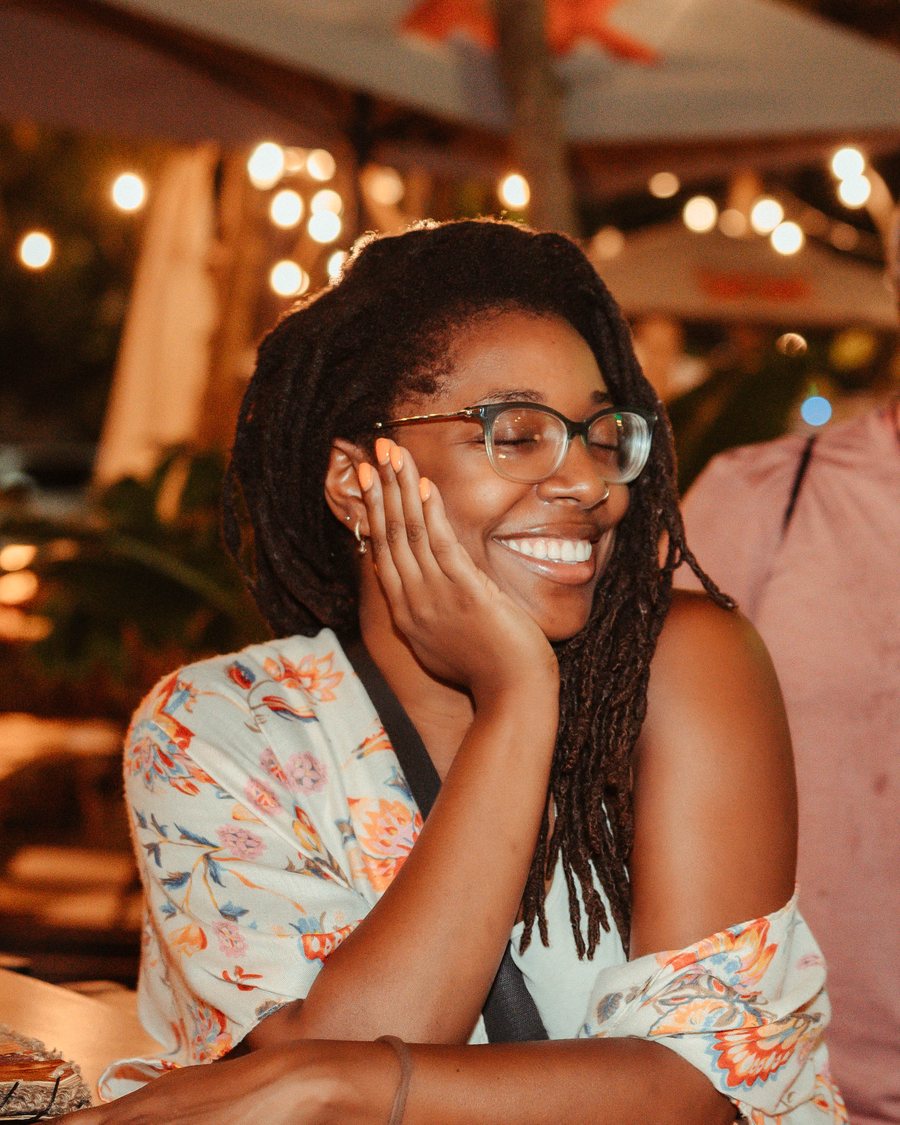 Ana the Marketeer laughing with her chin resting on her hand at a digital marketing meetup